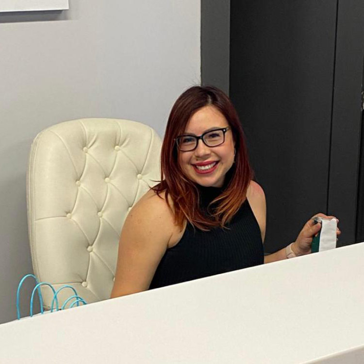 Blanca sitting behind the desk at Lashes by Design